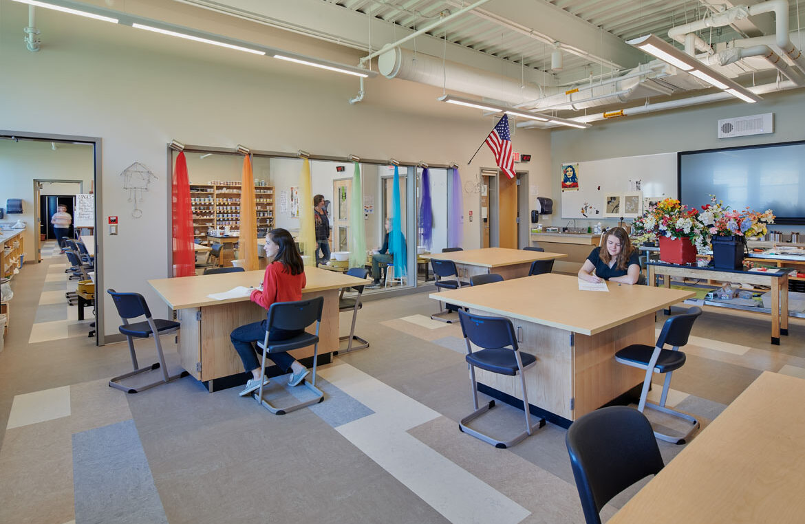 A photo of an interior art classroom with pottery and drawing desks at Morse High School